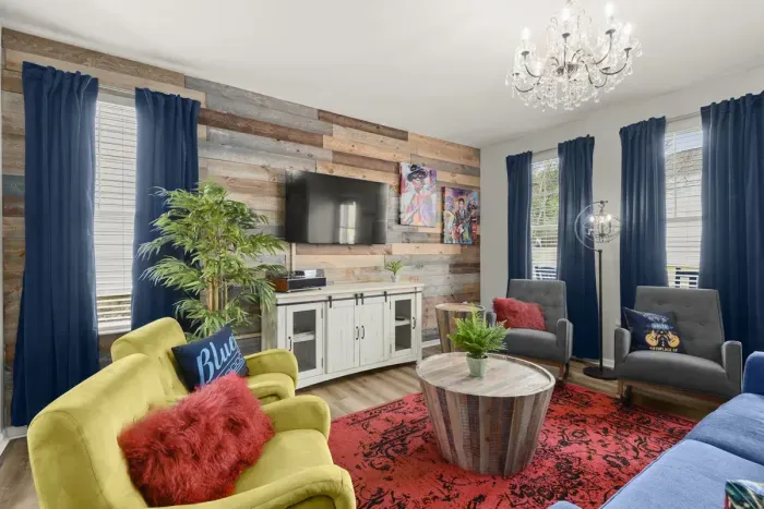 The deep red rug, natural wood accents and plush comfortable designer furniture will make you never want to leave. Trust us, we never want to leave this space either!