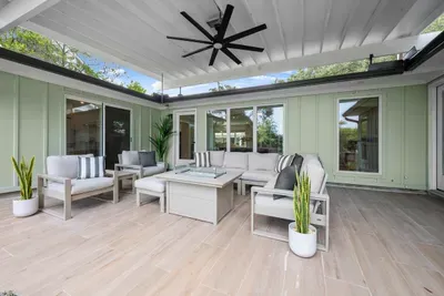 Relax on the covered patio with comfortable outdoor seating.
