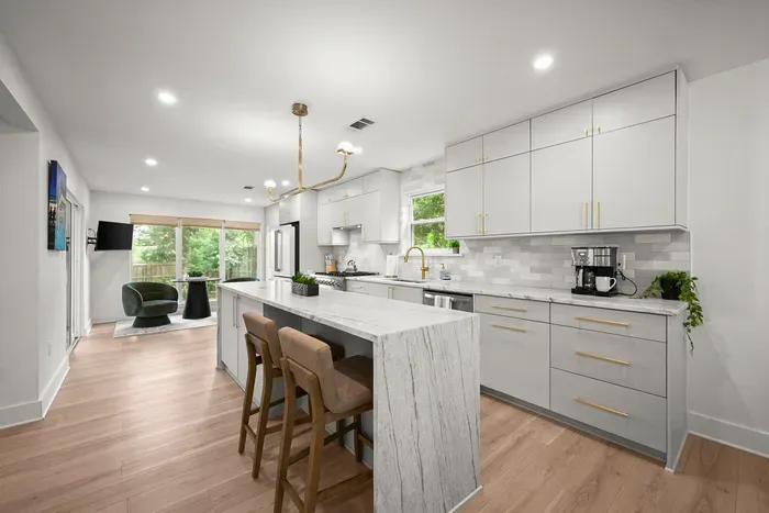Another view of the bright, fully equipped kitchen with plenty of space to cook and gather.
