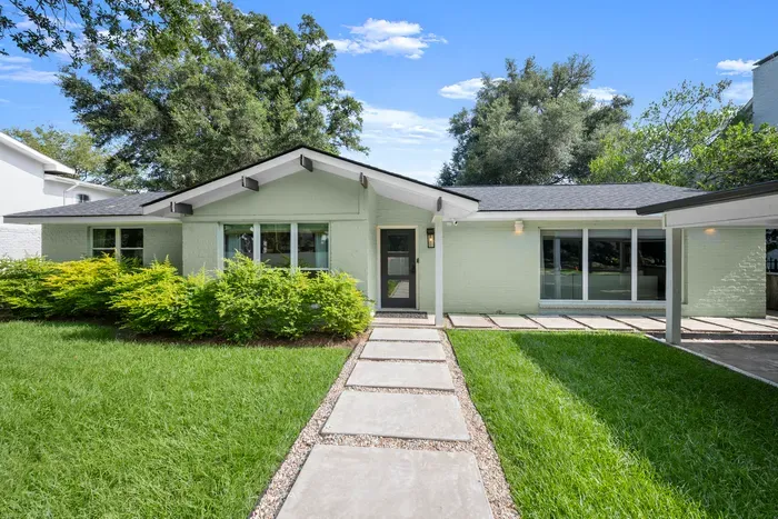 Follow the welcoming walkway to your modern home away from home, surrounded by beautiful landscaping.