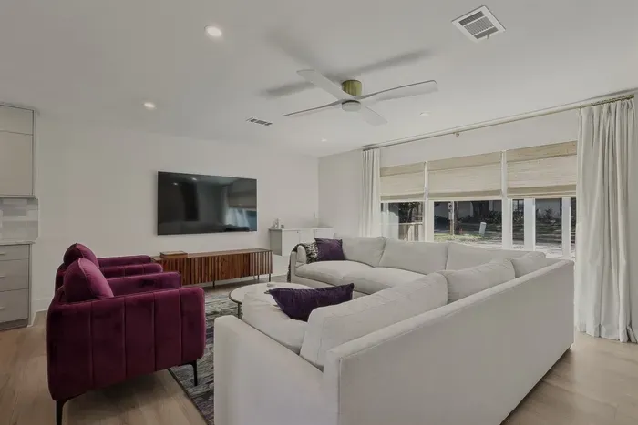 Bright open-concept living with cozy designer touches 🤍 The perfect gathering space for your group.