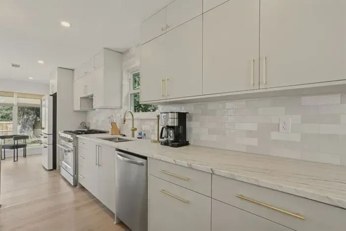 Clean lines, gold accents, and a chef-worthy setup. The heart of the home starts here.