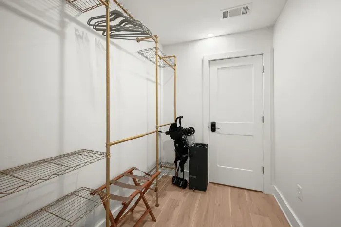 Spacious walk-in closet with ample shelving, hanging space, and room for your luggage.