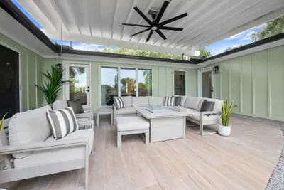 Another view of the spacious covered patio, perfect for relaxing, dining, and spending time together outdoors.