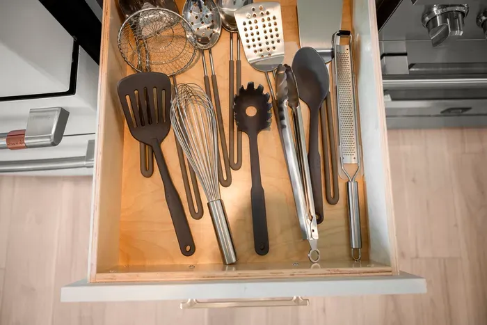 A fully stocked utensil drawer provides all the essential cooking tools you need to prepare and enjoy home-cooked meals.