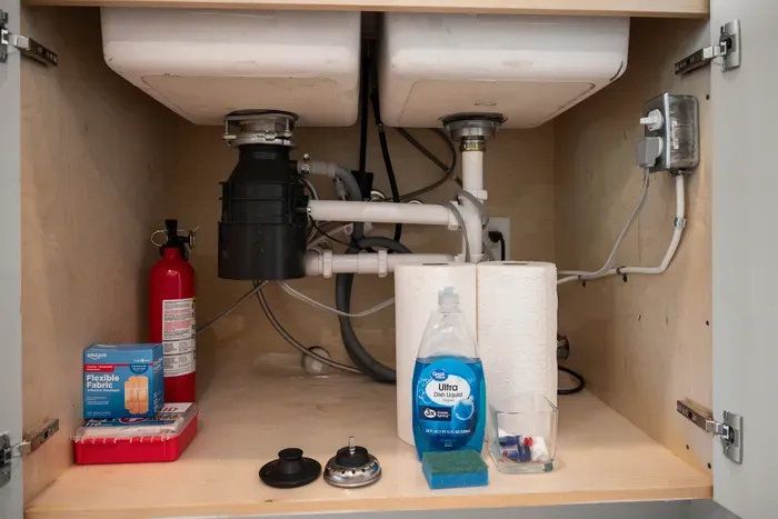 Additional cleaning supplies are conveniently stored under the sink.