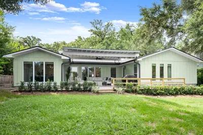 Enjoy the spacious backyard featuring a covered patio, lush lawn, and plenty of room to relax and unwind.