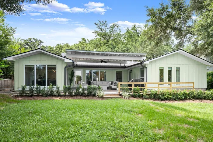 Enjoy the spacious backyard featuring a covered patio, lush lawn, and plenty of room to relax and unwind.
