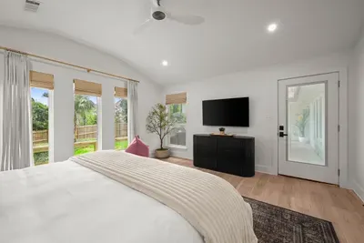 Enjoy the spacious primary suite with a Smart TV, abundant natural light, and peaceful backyard views.