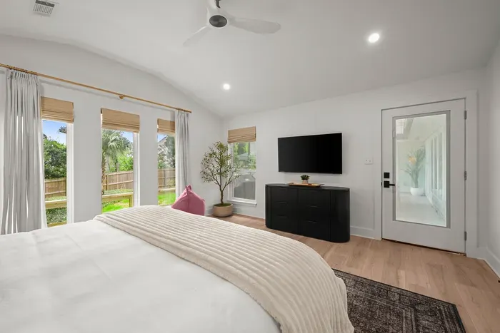 Enjoy the spacious primary suite with a Smart TV, abundant natural light, and peaceful backyard views.
