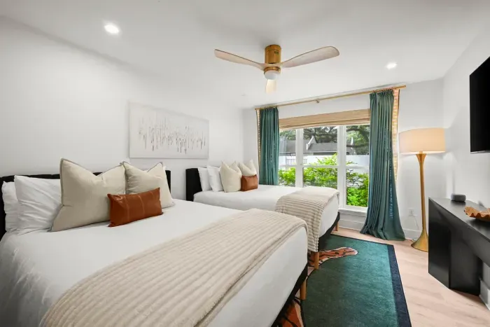 Spacious bedroom with two beds, perfect for family or friends.
