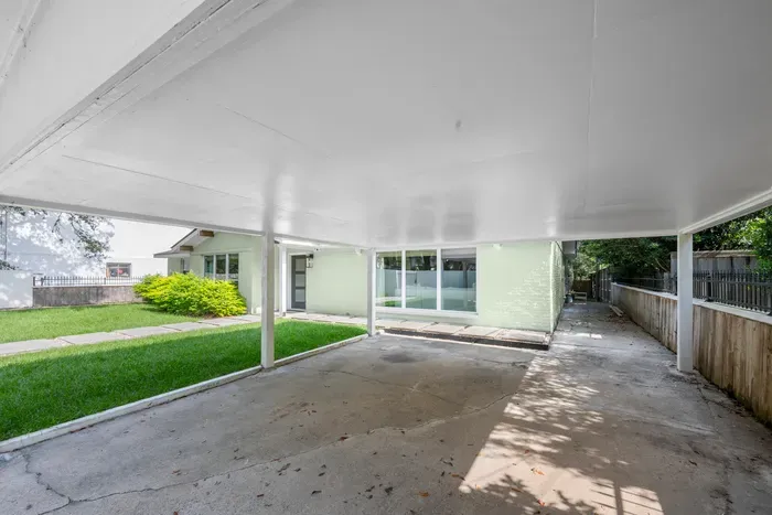 Covered carport offers convenient, weather-protected parking with easy access to the home.