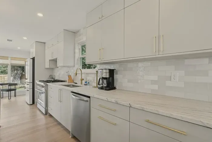 Modern finishes, gold accents, and plenty of prep space make this kitchen the heart of the home 🍽️