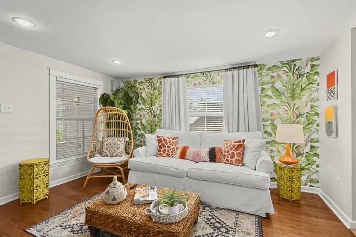 You will absolutely fall in love with the boho vibes of this living room, the playful accent chair and colorful decor make it a perfect cozy retreat