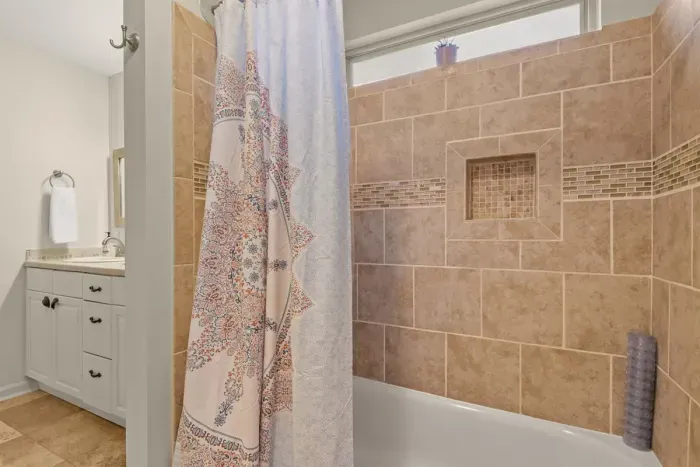 Tiled shower with tub combo.