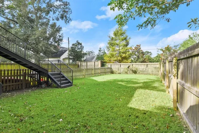 Stairway from your back balcony to your fenced in back yard area.
