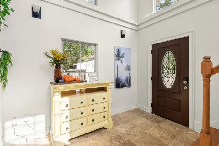 A light-filled entryway with high ceilings, warm décor, and a relaxed coastal-inspired feel.