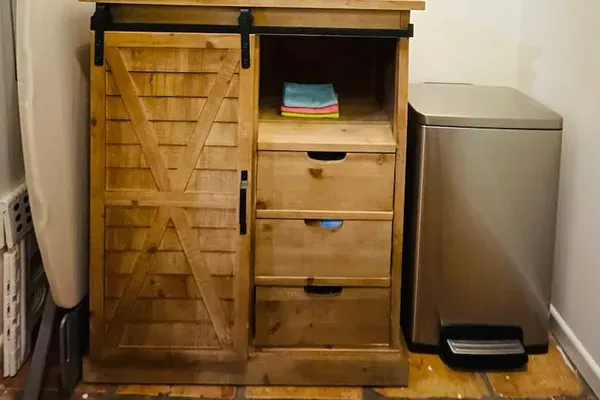 The laundry room is equipped with Oxy Clean, All laundry pods, dryer sheets, full size ironing board, iron, step stool, cleaning supplies and step trash can.