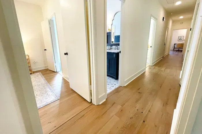 Room layout looking down the main hallway 
•King Green bedroom
•Double vanity bathroom
•Queen Driftwood bedroom
•Master King bedroom with ensuite at the end of the hall.