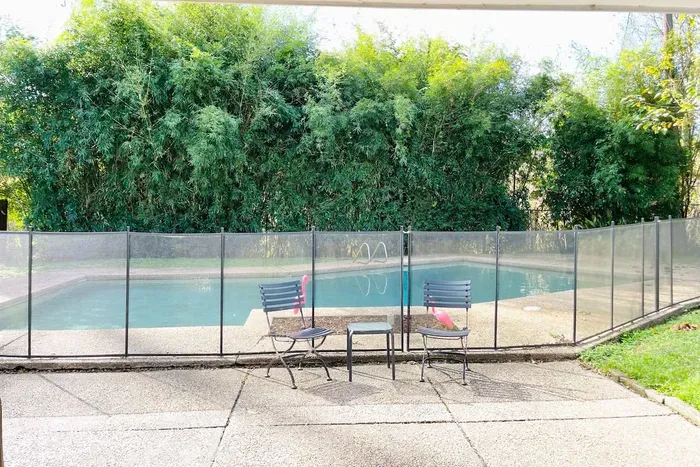 Private fully fenced pool with safety fence surrounding pool.