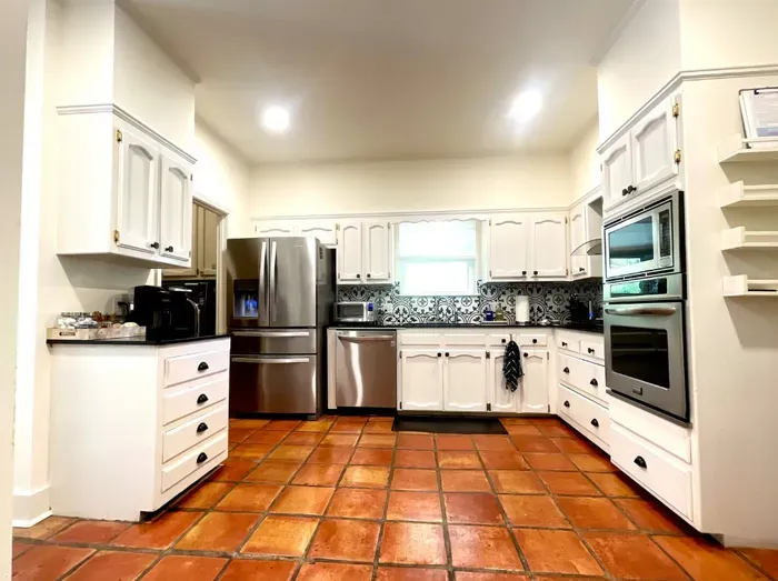 The spacious kitchen is designed for both convenience and comfort, offering ample counter space, essential appliances, and a welcoming area to cook, gather, and create memories during your stay.