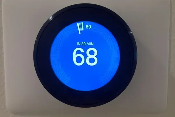 Nest thermostat located in the main hallway.