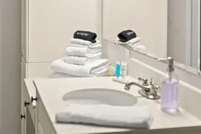 Accompanied by a stack of fresh towels awaiting your stay