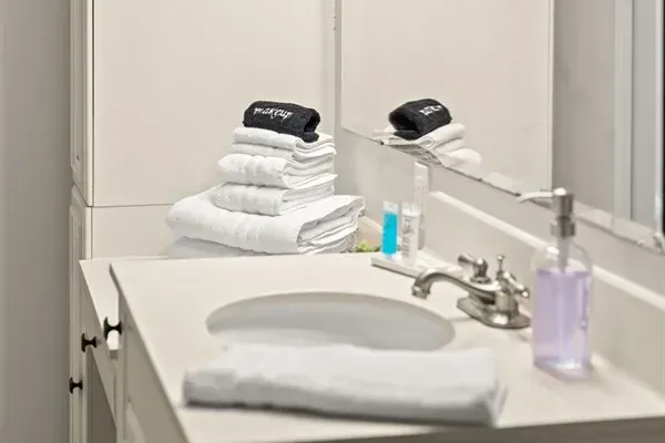 Accompanied by a stack of fresh towels awaiting your stay