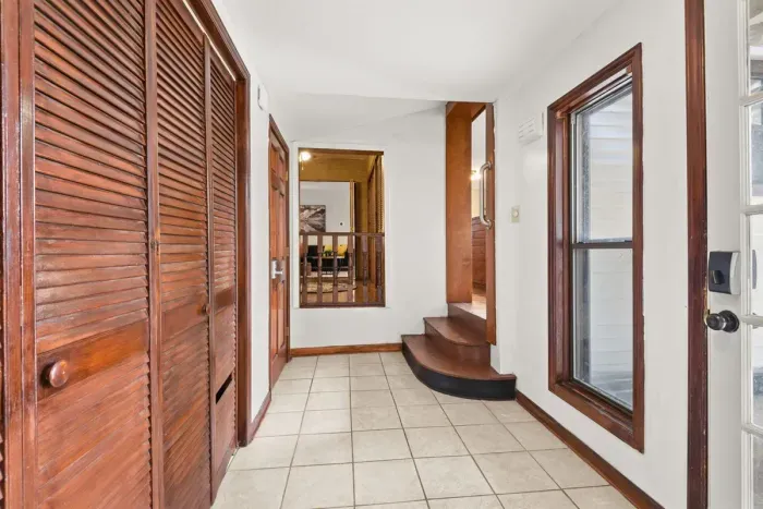 Welcome to a home with pristine charm, featuring a clean and wide hallway.