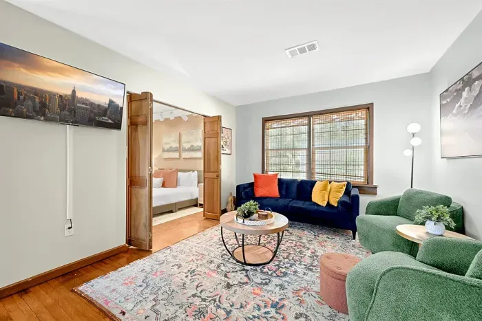 Discover the allure of this home adorned with tasteful wooden furnishings, creating an inviting environment that seamlessly harmonizes with the chic and stylish chairs, elevating the overall a