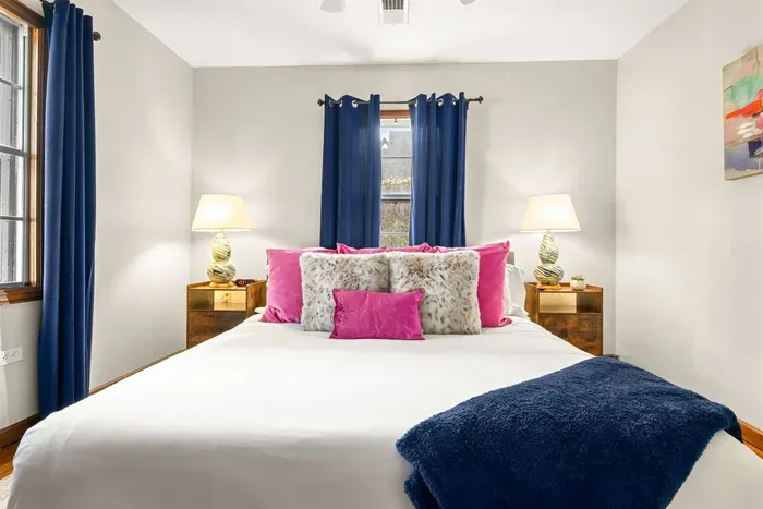 Indulge in the ultimate relaxation with a bedroom featuring a sumptuously comfortable bed complemented by elegant room-darkening curtains, creating a tranquil retreat where luxury meets serene ambiance.