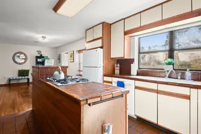 Delight in the culinary possibilities of a spacious kitchen, fully equipped with essentials, inviting you to enjoy and have fun while preparing meals in the heart of this welcoming home.