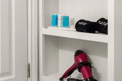 Pamper yourself in the bathroom of this home, where convenience meets indulgence with provided essentials like a hairdryer and bath kits.