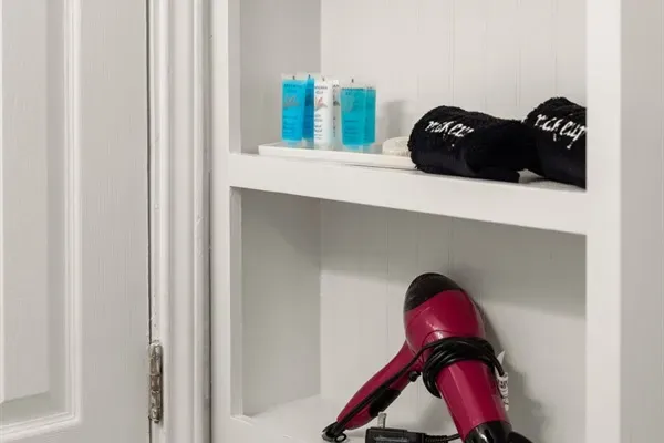 Pamper yourself in the bathroom of this home, where convenience meets indulgence with provided essentials like a hairdryer and bath kits.