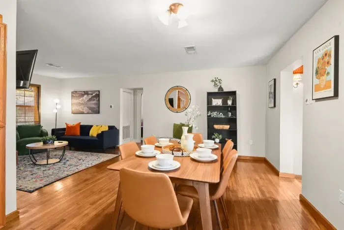 Gather around a welcoming dining table in this home, fully equipped with all the essentials for a delightful and enjoyable dining experience.