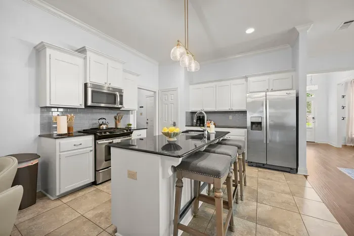 A bright, modern kitchen with plenty of counter space and seating for casual meals.