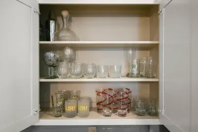 A well-stocked glassware cabinet with a variety of glasses and serving pieces for your stay.