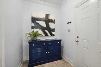 Make yourself at home with this inviting entryway, thoughtfully decorated with comfort and style in mind.