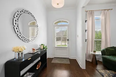 Step into a beautifully styled entryway featuring a statement mirror and inviting touches.