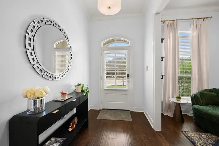 Step into a beautifully styled entryway featuring a statement mirror and inviting touches.