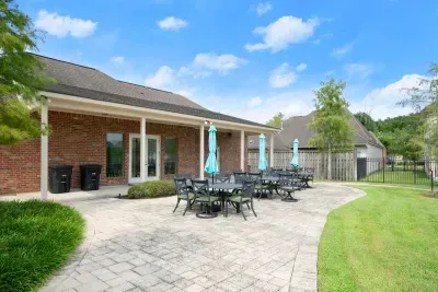 A private outdoor space with comfortable seating, a beautiful lawn, and room to gather.