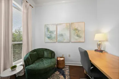A cozy home office nook with a comfortable chair, spacious desk, and plenty of natural light.