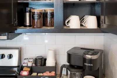 Savor your mornings with a delightful coffee bar and a variety of mugs available in this unit, ensuring you have everything you need for a perfect cup of coffee