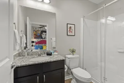Clean toilet and fresh towels await to elevate your stay