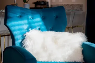 .Refined coziness: Embrace the grace of our blue chair and cozy throw
