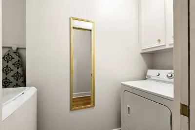 Laundry space in unit with washer, dryer and detergent.