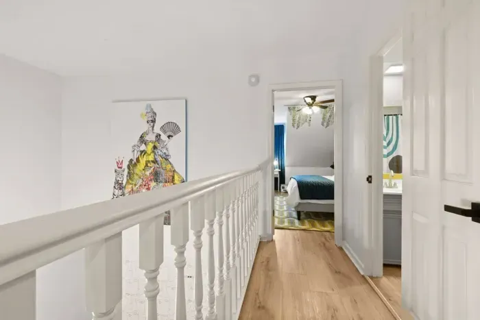 Upstairs banister walking into the private upstairs guest suite.