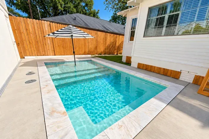 Between the main home and game room, your private modern sunlit cocktail pool awaits for the whole family to relax and enjoy in the heart of the Garden District.