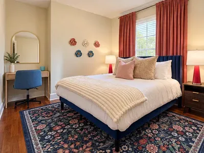 Spacious king guest bedroom with floral notes and work space