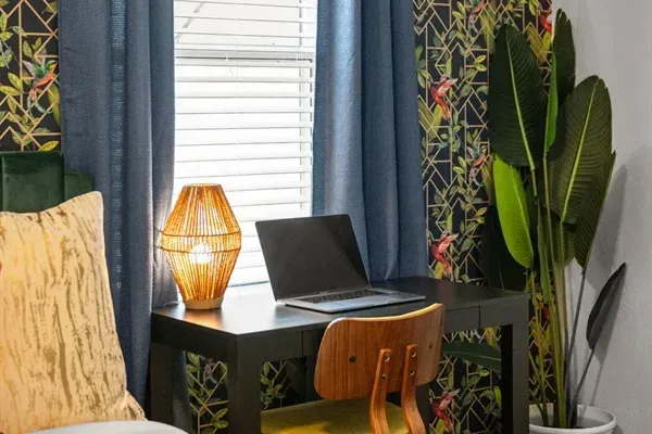 Enhance your productivity with the convenient desk situated beside the table, offering a dedicated space for work or study in the comfort of your own home.